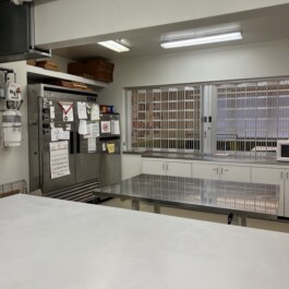 Kitchen with white prep table, stainless steel prep table, and two fridges, Vancouver Japanese Language School & Japanese Hall